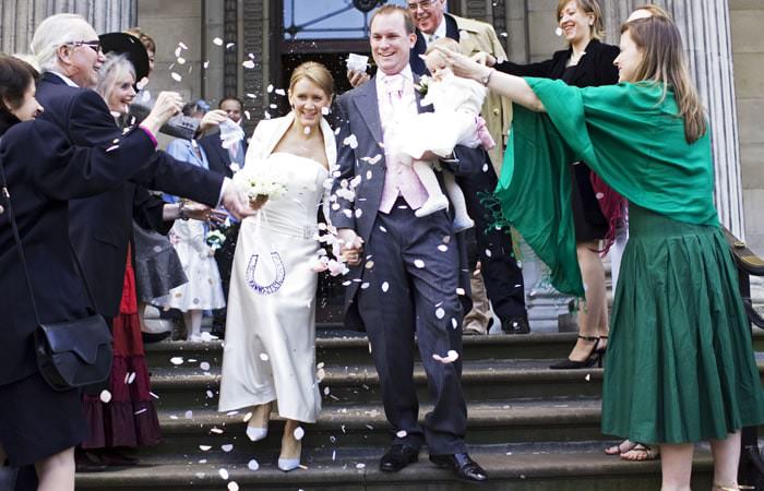 bride and groom with confetti on register office steps Sara and Jamess Wedding Photographed at Claridges Hotel in London