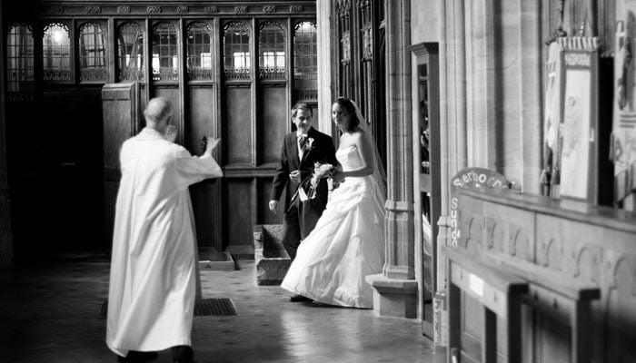 Wedding photograph in black and white of Rosie and Mark in Sherborne Abbey after the service Wedding Photographer for Rosie & Mark at Sherborne Abbey, Dorset