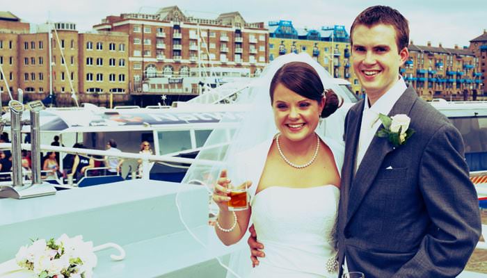 Wedding photograph of Emma and Steven on boat trip down Thames Wedding Photographer for Emma and Steven, at All Hallows by the Tower, Boat Trip & Fulham Palace, London