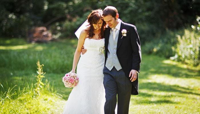 Wedding Photograph of Bride and Groom walking at Fulham Palace Wedding Photography taken at St Barnabas Church, Clapham Common and Fulham Palace, London
