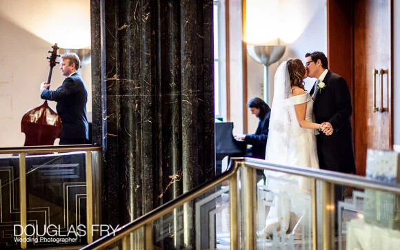 Bride and groom kissing at RIBA in London
