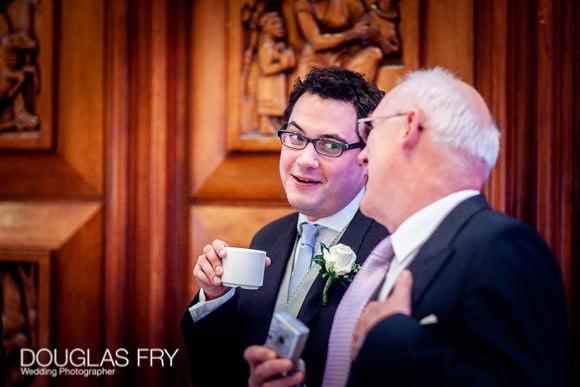 Groom in conversation at wedding at RIBA