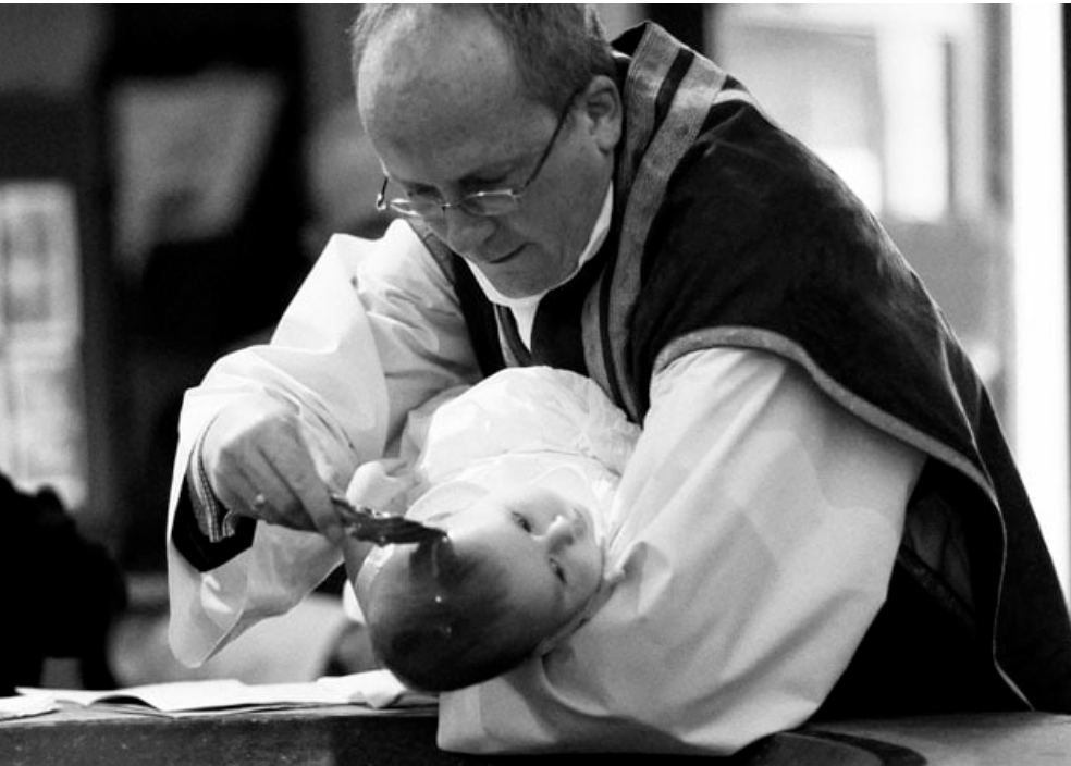 christening photograph of baby with vicar
