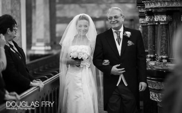 Wedding photograph in black and white of bride and father in Synangogue