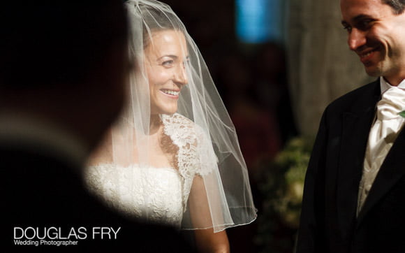 Bride and groom photographed during wedding ceremony in London