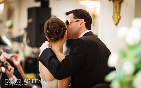 Groom photographed kissing bride at Berekeley Hotel 