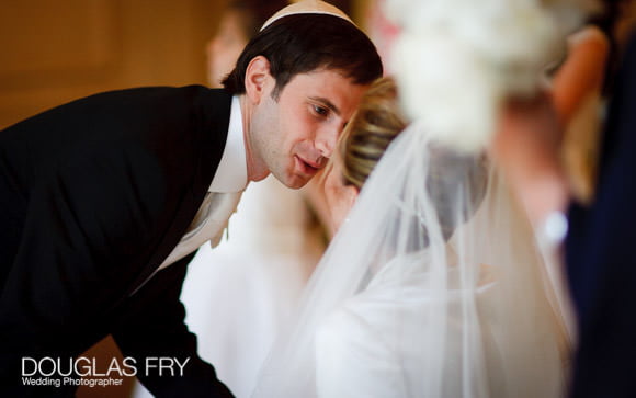 Groom kissing the bride at the Mandarin in London