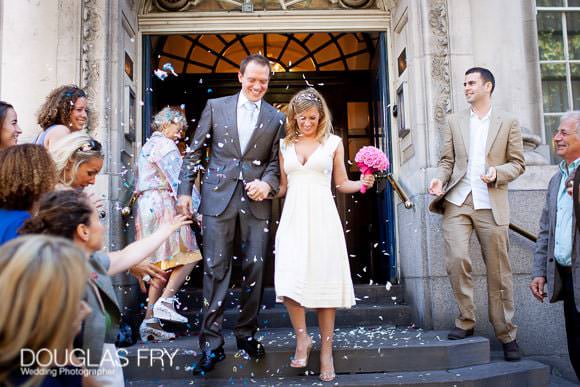 Pink Colour bouquet at Chelsea Register Office - couple on steps with confetti