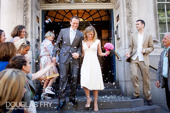 Wedding with Pink Colour Scheme at Ranelagh Gardens, The Royal Hospital, Chelsea 3 Pink Colour bouquet at Chelsea Register Office - couple on steps with confetti