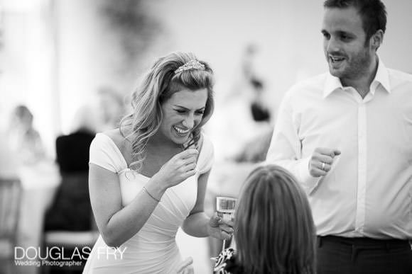 Black and white wedding photograph of bride laughing