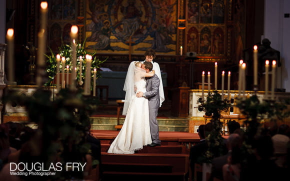 Wedding photograph HTB of couple kissing at end of service
