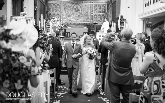 wedding photograph of couple leaving the church in London