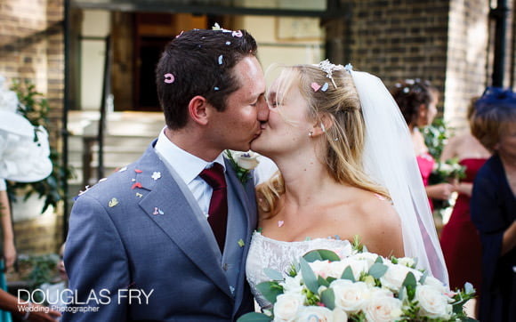 Couple kiss at end of wedding service