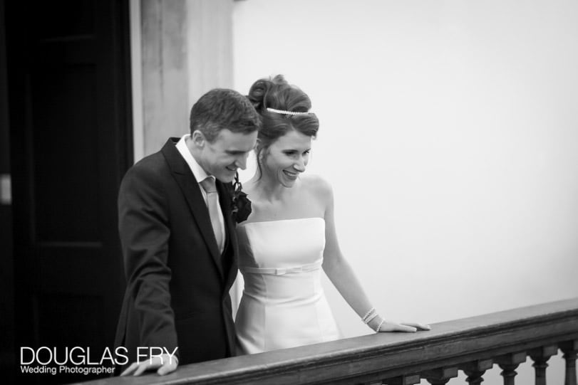 Wedding Photographer Queens House - Greenwich - couple looking over balcony