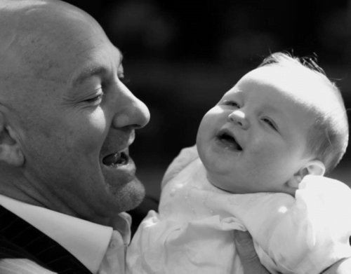 father and baby photographed at London chirstening