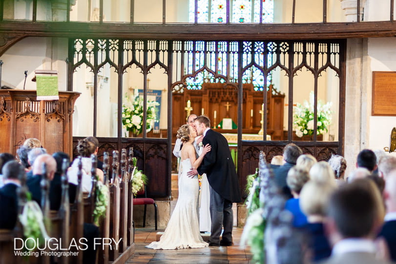 wedding photographer norfolk church - couple kissing