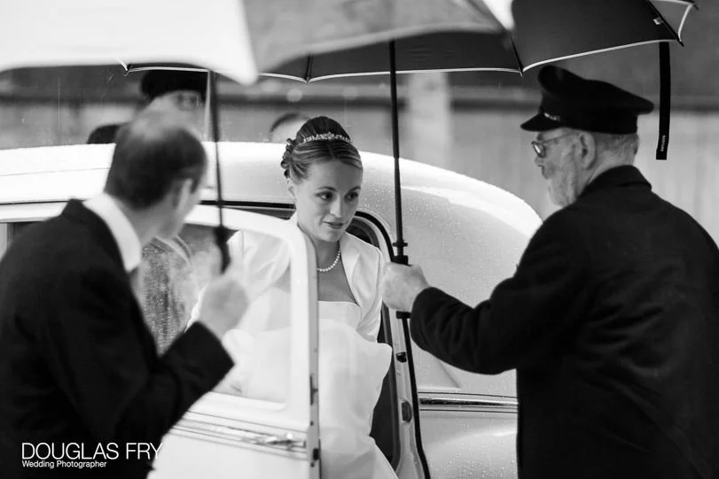 Helen and William's Wedding Photographs at St Stephen Walbrook and Skinners Hall in London 3 Bride arriving with umbrellas - Wedding Photography at St Stephen Walbrook and Skinners Hall in London