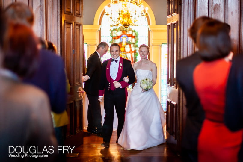 Bride and groom entering dinner at HAC on wedding day