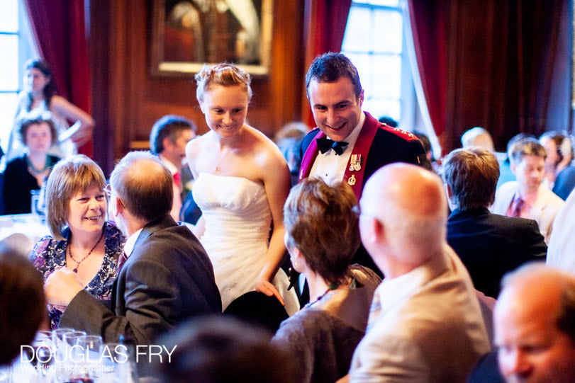 bride and groom speaking to guest during wedding