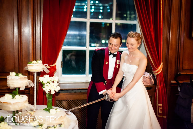 cutting wedding cake photographed at HAC in London