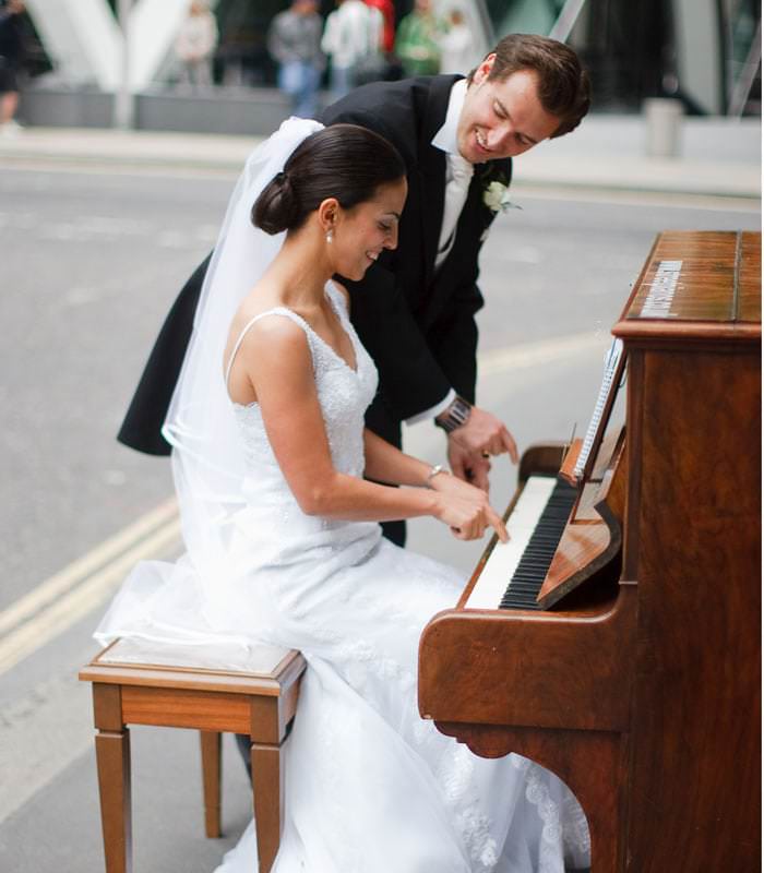 bride and groom playing the piano
