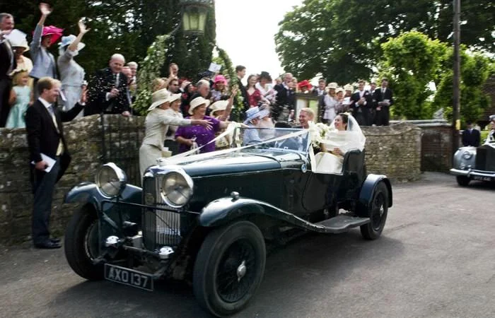old car outside church in dorset with confetti Daisy and James Wedding Photographed at home in Dorset 1