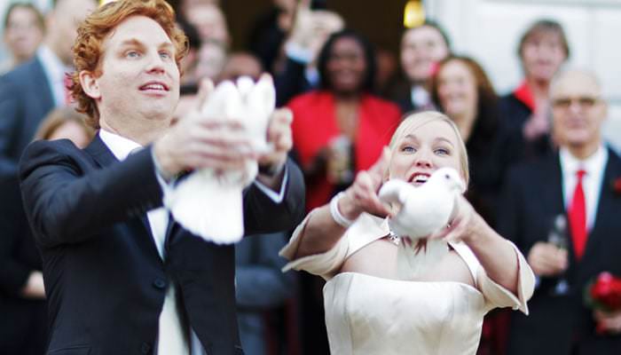 Bride and groom releasing white doves Red Themed Wedding at The Queen's House in Greenwich for Marrit & Jasper 1