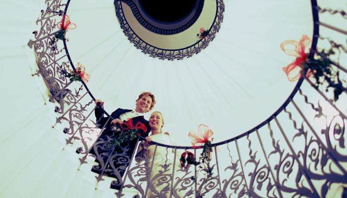 Bride and groom on spiral staircase at Queen's House Red Themed Wedding at The Queen's House in Greenwich for Marrit & Jasper 4