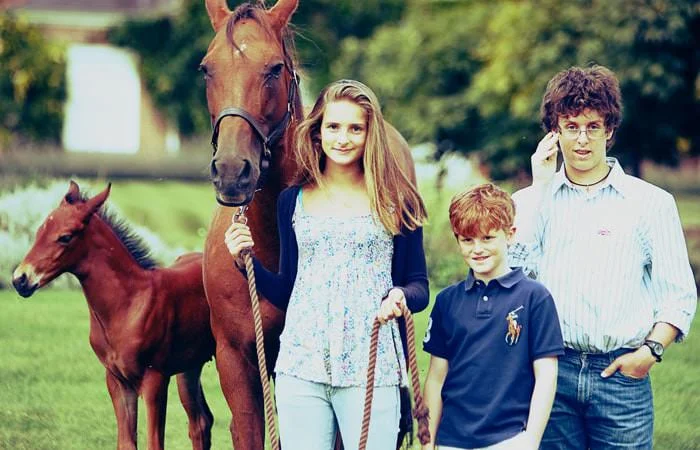 daughter and sons with mare and foal Family photographs of the children at home with mare and foal 1