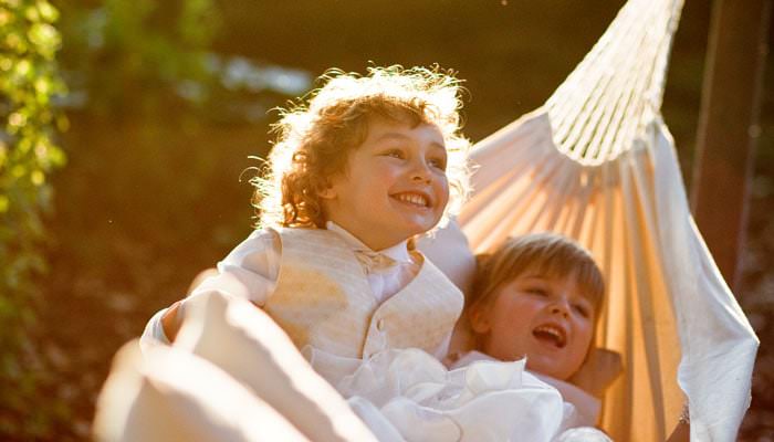 Bridesmaid and page boy photographed in hammock at wedding in Richmond