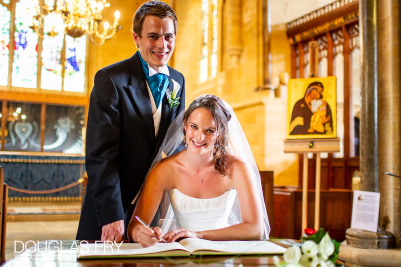 Wedding Photographer - Dorset - signing the register in Sherborne Abbey