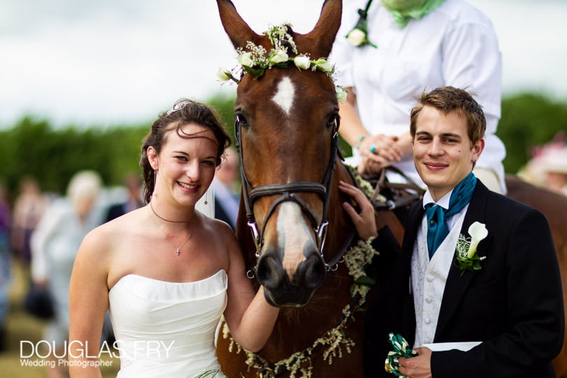 Horse photographed with bride and groom at Dorset wedding reception