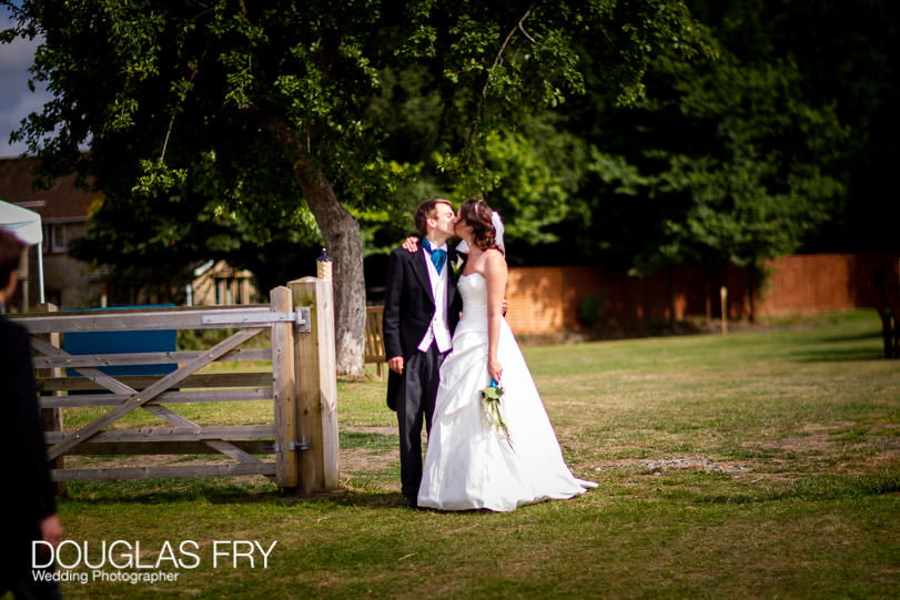 Bride and groom photographed kissing in Dorset