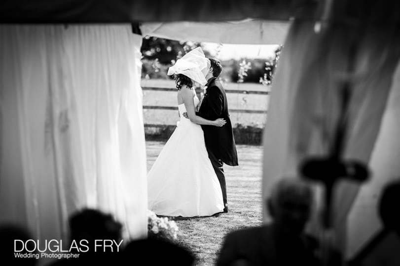 Bride and groom outside marquee during Dorset wedding