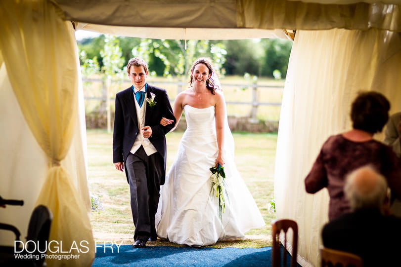 Wedding photographer Dorset - couple entering marquee