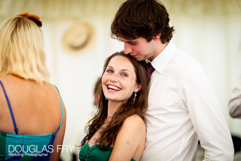 Guests photographed during Dorset wedding reception in marquee