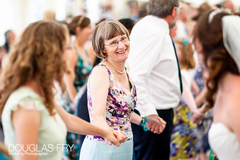 Guests at wedding reception dancing