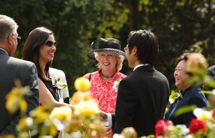 Wedding Photograph at guests outside in the gardens at the Belvedere, Holland Park, London