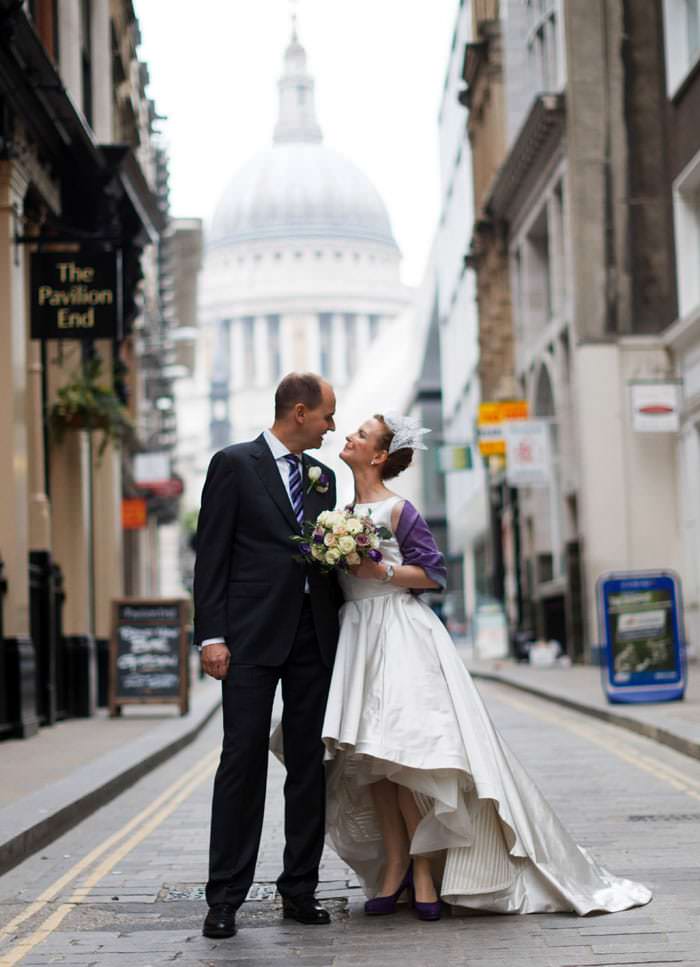 Wedding photograph of bride and groom outside in London with St Paul's in background
