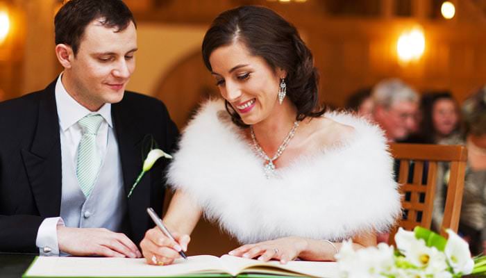 Wedding Photograph Signing the Register at Rivervale Barn Hampshire