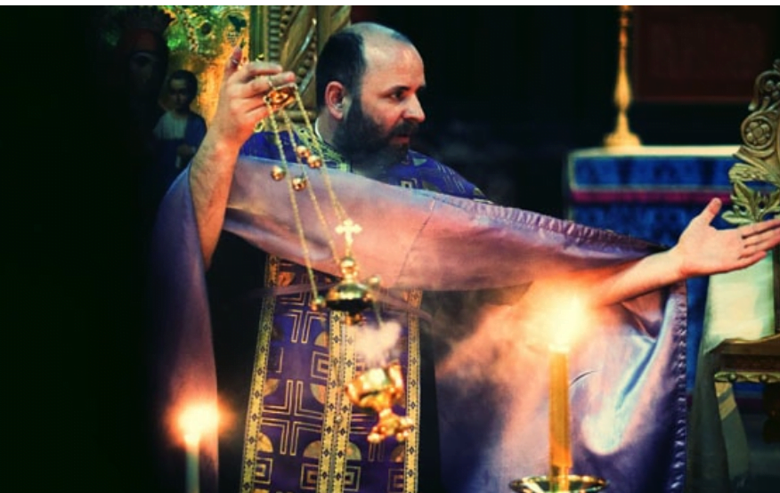 Vicar in church in London during Christening