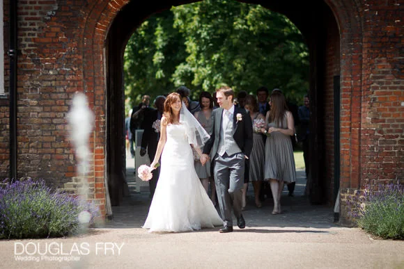 Wedding Photography at St Barnabas Church, Clapham & Fulham Palace, London 2 Bride and groom photographed entering grounds of Fulham Palace in London