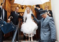 Wedding Photographer london - bride with umbrella leaving synagogue