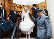Wedding Photographer london - bride with umbrella leaving synagogue
