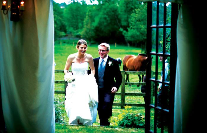 Wedding Photograph Bride and Groom entering Marquee