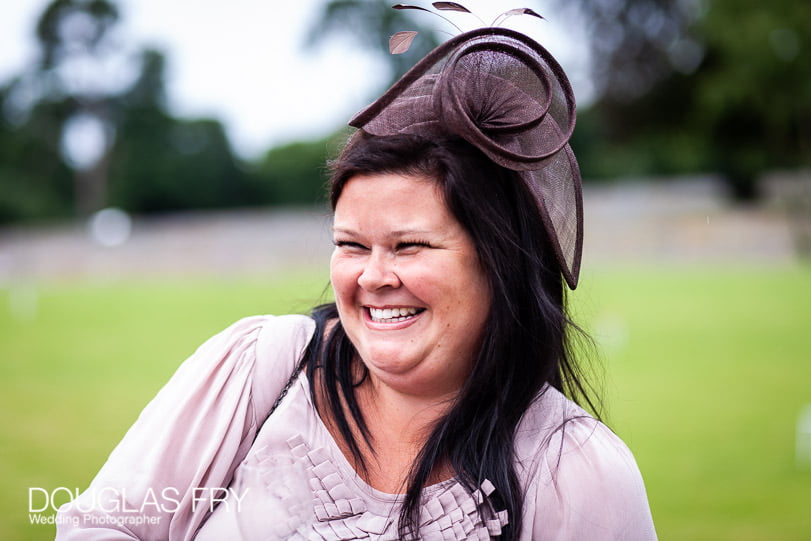 Wedding photograph of smiling guest at Coworth Park