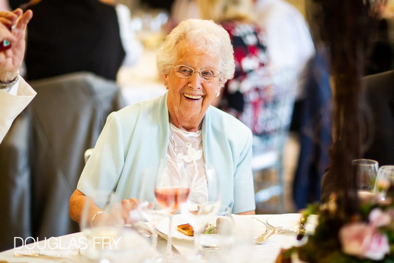 Guests laughing during wedding reception at Coworth Park