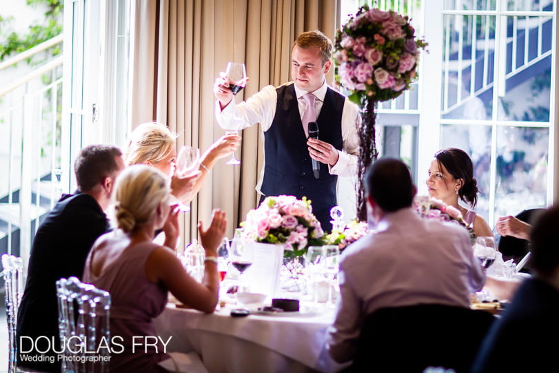 raising a toast during wedding at Coworth Park