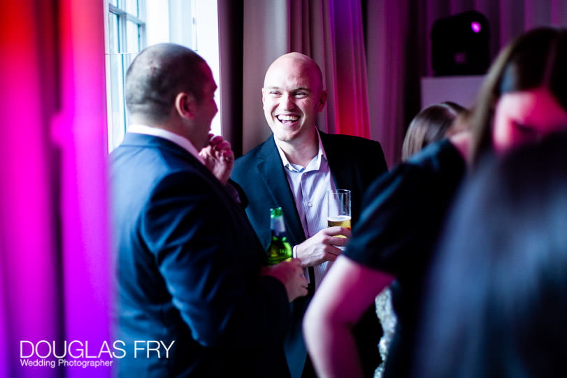 Smiling guests photographed during wedding reception