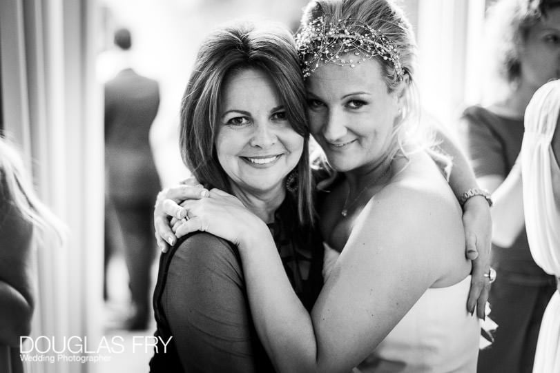 Bride photographed with friend during wedding day